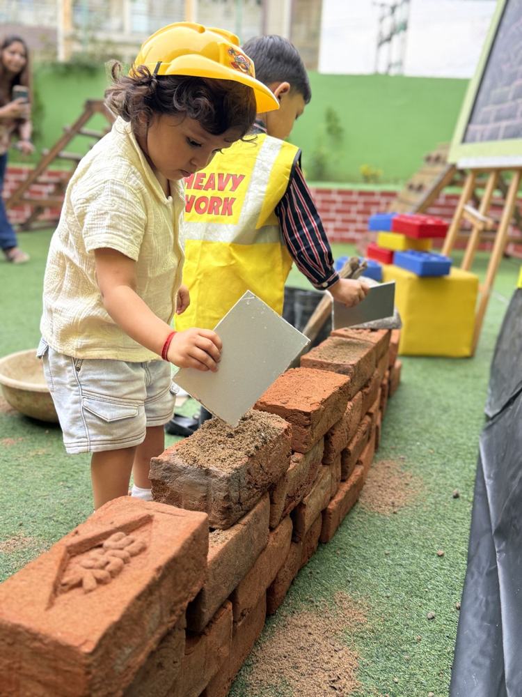 A child laying bricks with a trowel